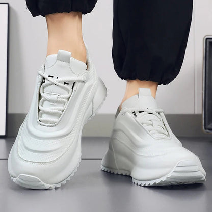 White sneakers worn with black pants on a neutral background, featuring the brand 'Fashion Lauridsen'.