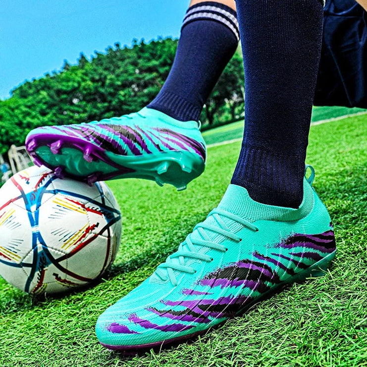 Person wearing green soccer cleats with purple accents on a grass field, kicking a colorful soccer ball.