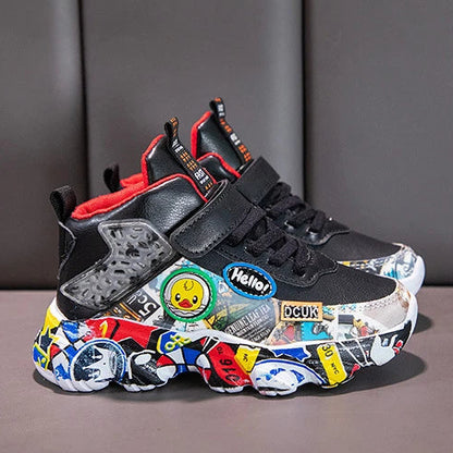 A pair of black high-top sneakers with colorful graffiti-style stickers and red accents, shown in two views against a dark gray padded background.
