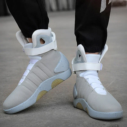 Light gray sneakers with white laces worn by a person on a concrete surface