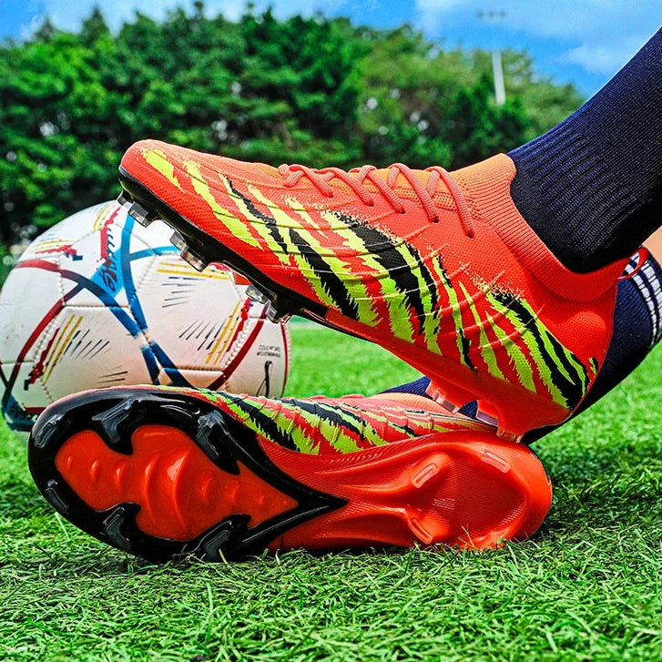Futuristic red and black shoe with a colorful soccer ball on grass