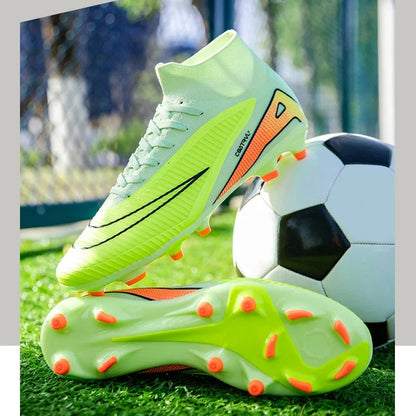Bright green soccer cleats with orange accents on grass, with a blurred soccer ball in the background.