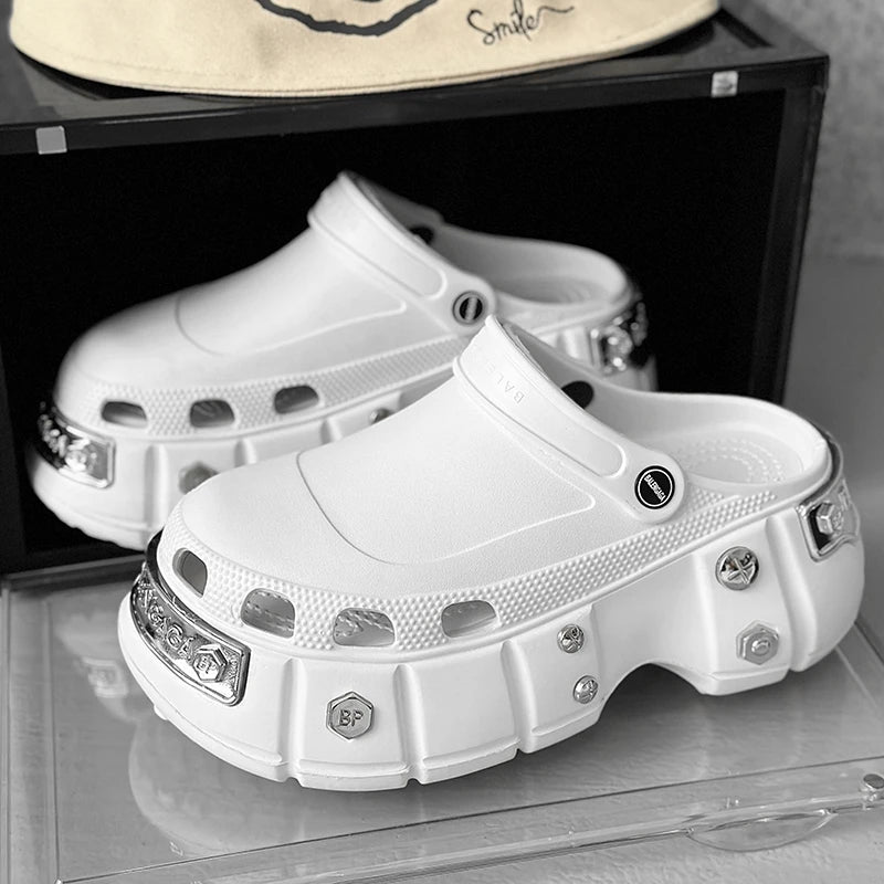 White clogs with decorative embellishments on a reflective surface.